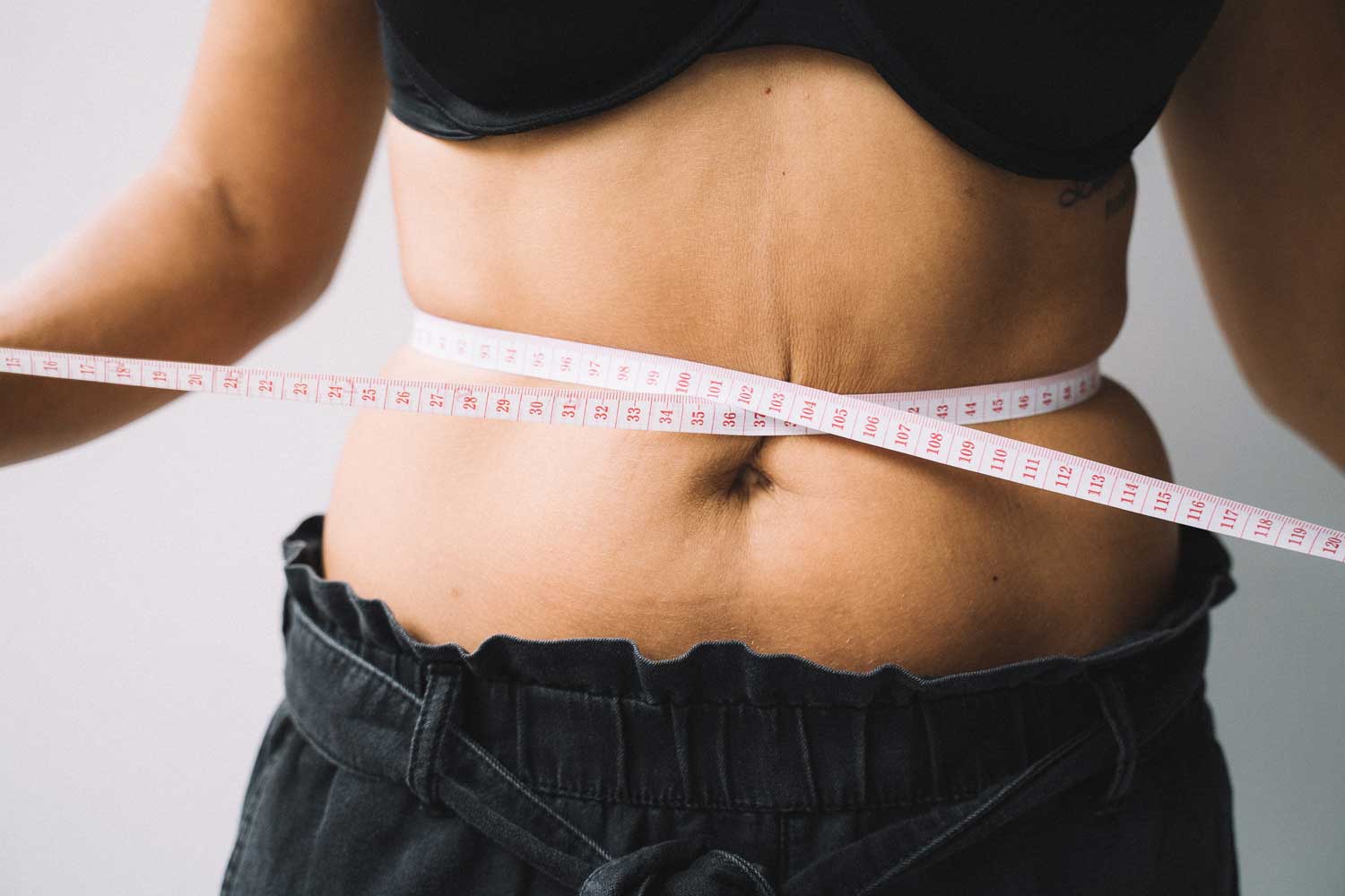 A Tummy With A Measuring Tape Around It—Is A Tummy Tuck The Right Choice For You.