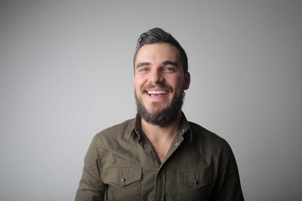 Smiling Man In A Dark Green Shirt